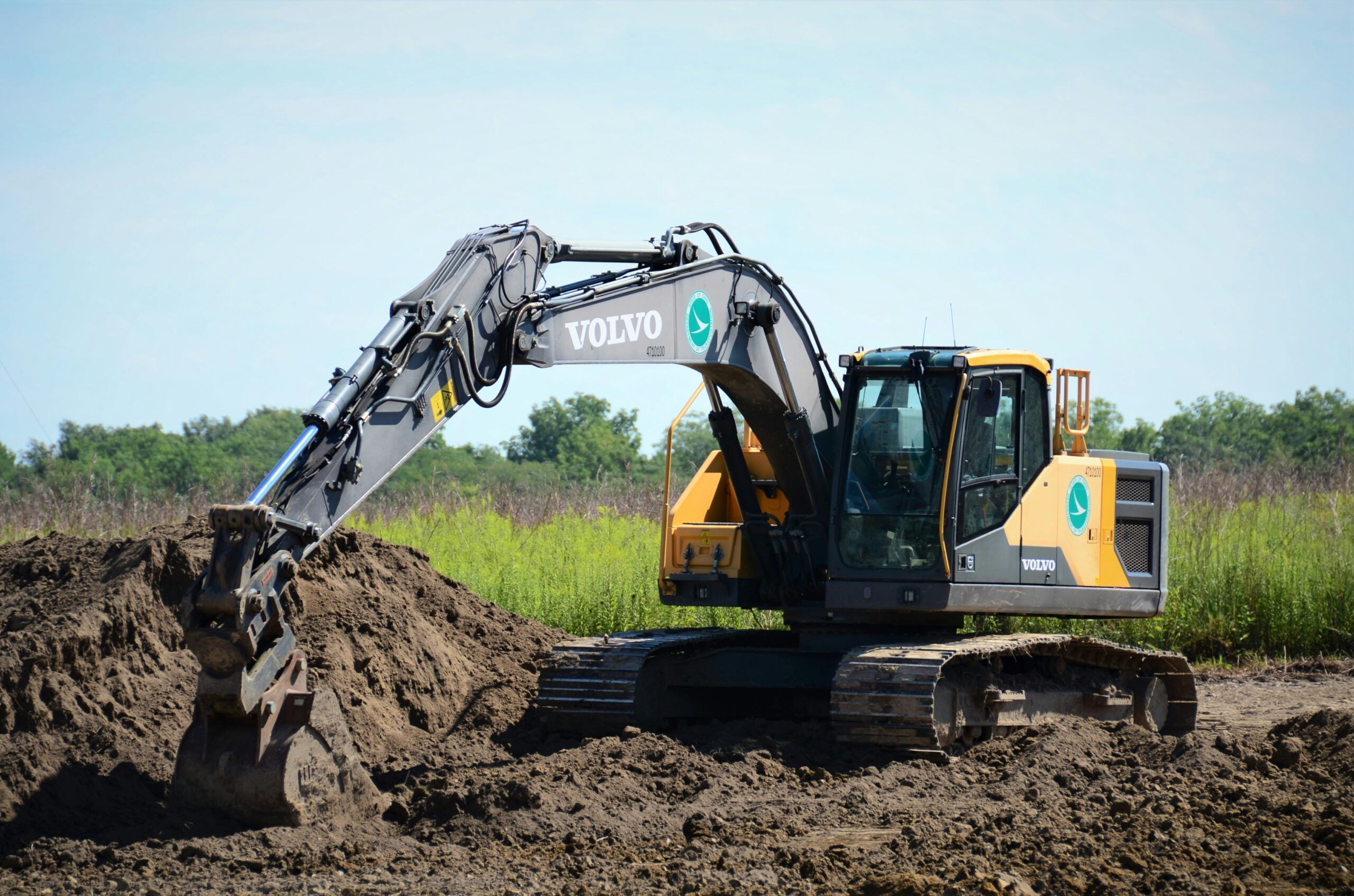 Backhoe digging a pond