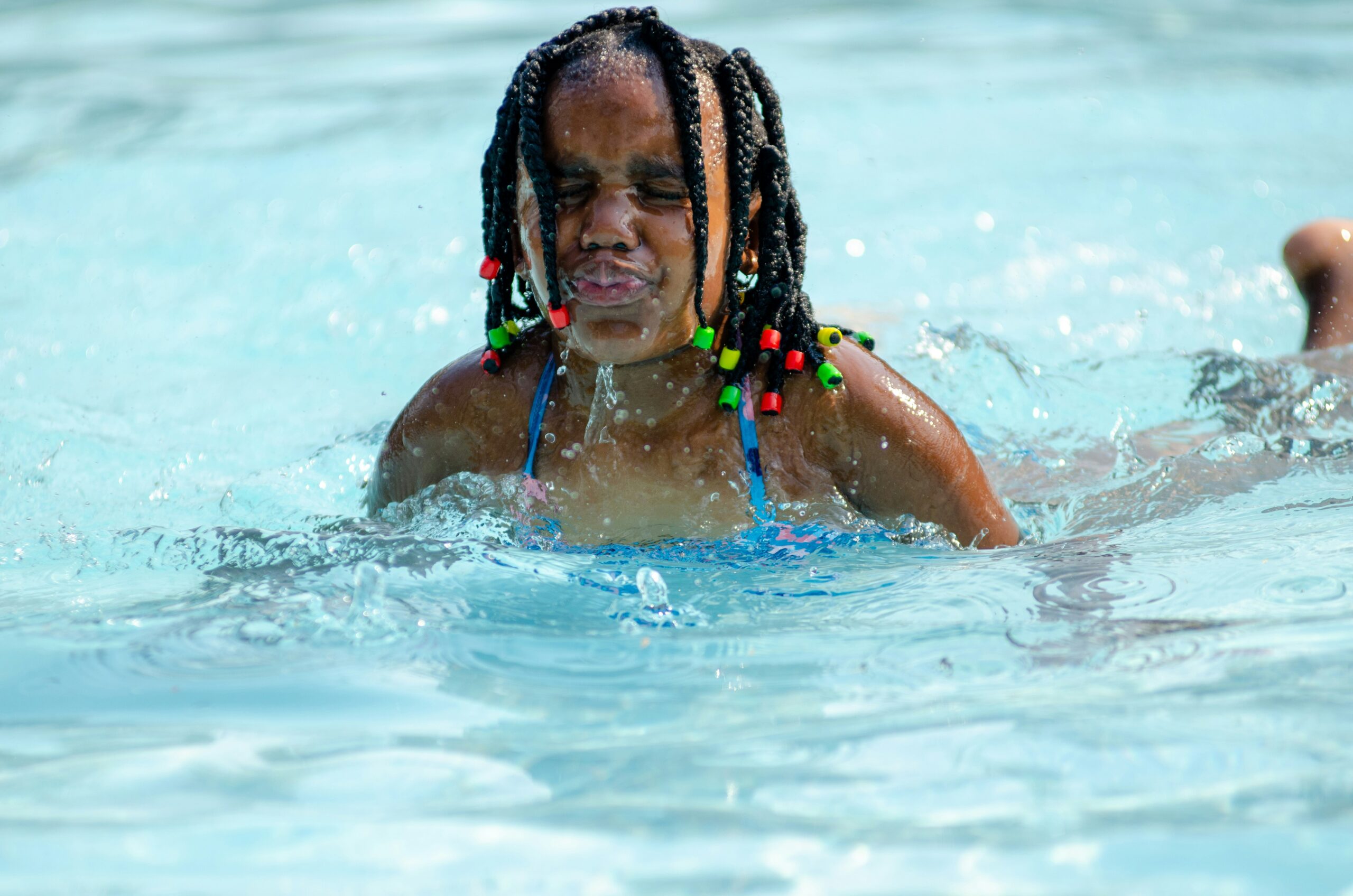 Young age girl having fun in pool